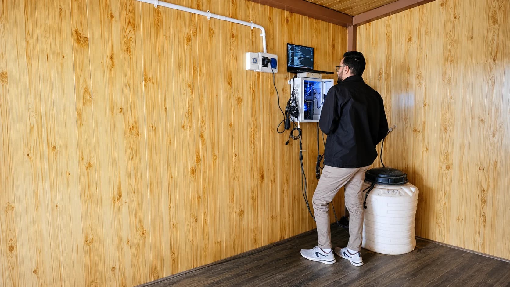 An iPlant engineer commissioning a controller unit on site.